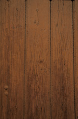 Close-up of worn planks of wood in an old brown door