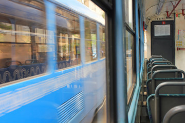 Tram interior with empty seats in old fashion public city transport in Moscow  