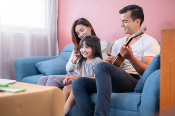 happiness family enjoy weekend together with sind and ukulele in family living room home concept