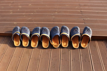 Close-up of several pair of slippers lying on level