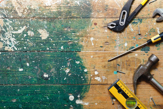 Flat lay set of vintage carpentry tools on colorful wooden background. Top view workbench with carpenter different tools. DIY, woodworking, craftsmanship and handwork concept 