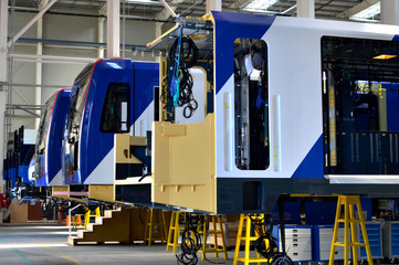 Inside of the rail car assembly plant. Industrial workshop for the production of European high speed trains. Factory of the manufacturing trainsets rolling for - Image