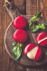 Small snack cheeses on the wooden board