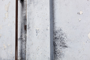 Textured background, plastered surface with cracked gray paint