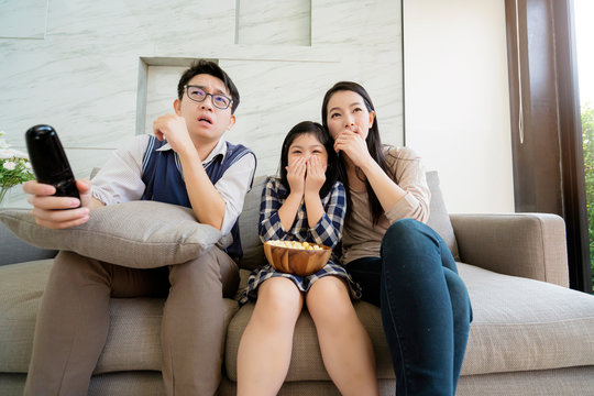 asian happiness Family talking and relaxing on sofa watch tv together
