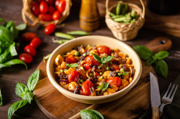 Corn paste with roasted tomatoes and fresh peas and onion