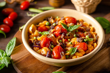 Corn paste with roasted tomatoes and fresh peas and onion