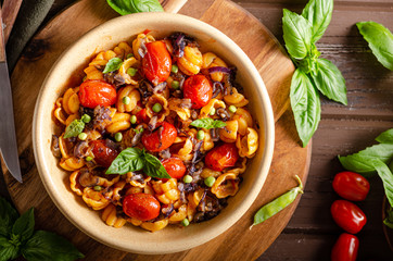 Corn paste with roasted tomatoes and fresh peas and onion