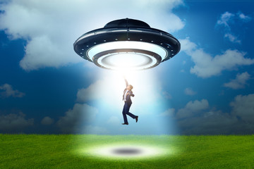 Flying saucer abducting young businessman 