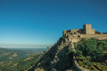 Fototapeta na wymiar Stone walls and tower of Castle over rocky cliff at Marvao