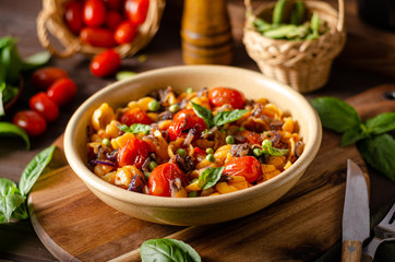 Corn paste with roasted tomatoes and fresh peas and onion