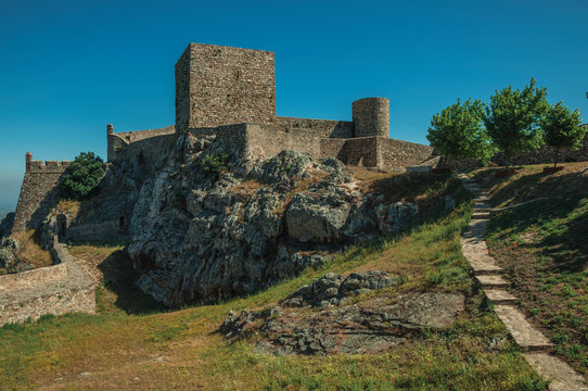 Walls and towers over rocky hill with garden at the Marvao Castle