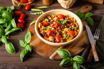 Corn paste with roasted tomatoes and fresh peas and onion