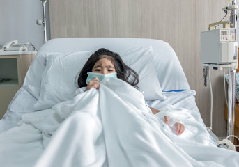 patient asian kid with mask have fever on hospital bed