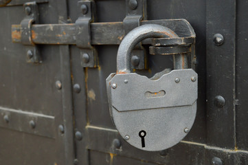 gray padlock on the iron door