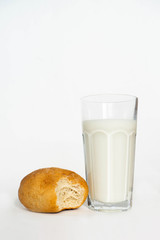 glass of milk and bread isolated on white background