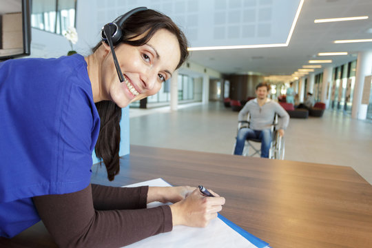 Portrait Of Hospital Receptionist Wearing Headset