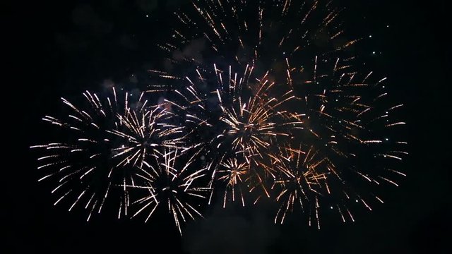 colored fiery sparks of festive fireworks in the night sky. time laps