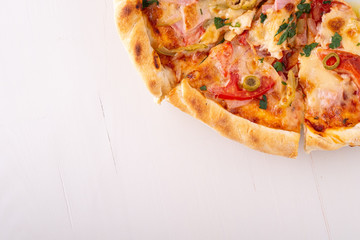 Half pizza on white wooden background copy space top view 