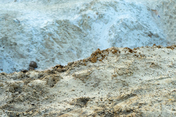 mountain of light colored sand on the beach 