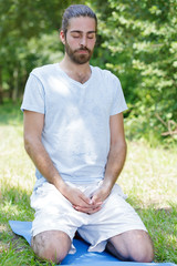 Naklejka na ściany i meble young man meditating outdoor