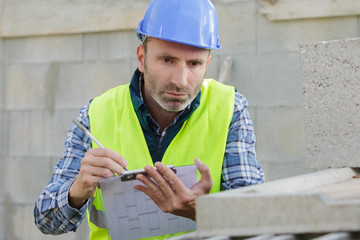 builder writing on clipboard