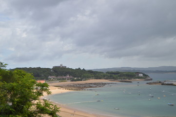Fototapeta premium Beautiful White Sand Beach Of The Dangers In The Background The Palace Of The Magadalena Is Found In Santander. August 24, 2013. Santander, Cantabria. Vacation Nature Street Photography.