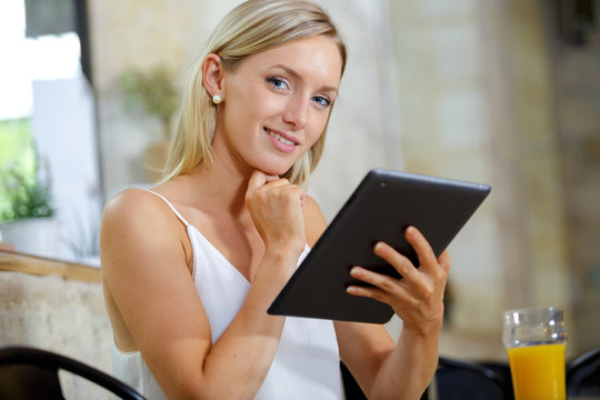 beautiful girl with tablet in the bar