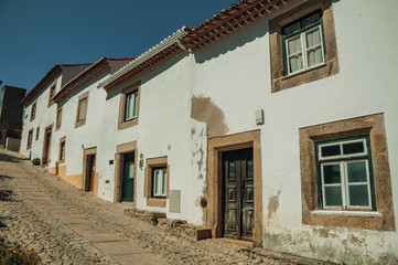 Old houses with whitewashed wall in an alley of Marvao