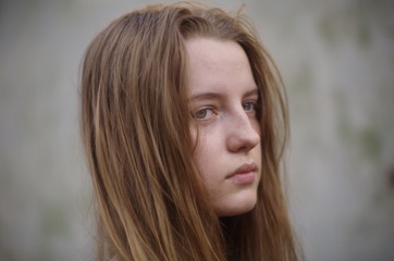 Fototapeta premium beautiful young blonde with long flowing hair on a blurry background
