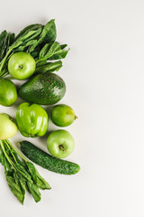 Green vegetables and fruits on white background