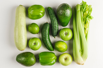 Green vegetables and fruits on white background