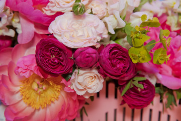 Colorful mixed bouquet with various spring flowers in floral decor, Colorful wedding flowers background . Mixed flower arrangement: various flowers in different shades of red, pink, yellow and orange.