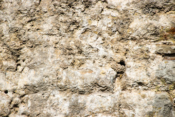 Old rough weathered stone wall texture