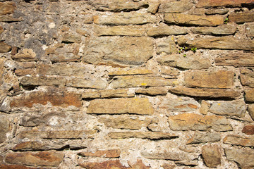 Old rough weathered stone wall texture