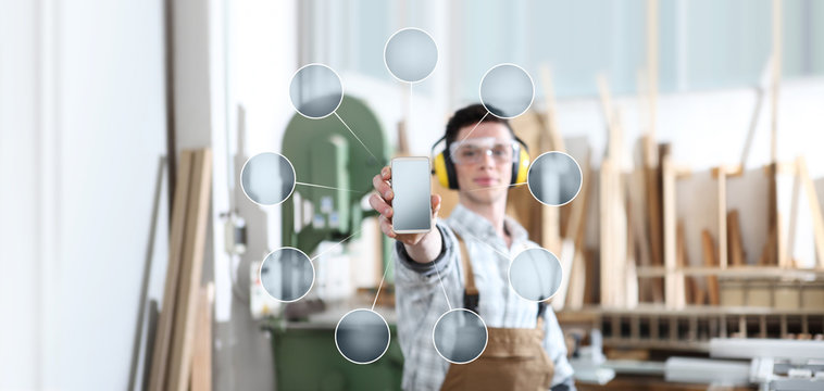 carpenter man show the mobile phone with empty symbol icons on carpentry background