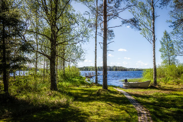 Fototapeta premium Summer landscape - the shore of the lake with boat
