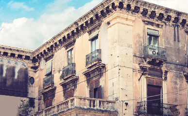 Traditional architecture of Sicily in Italy, typical street of Catania, facade of old buildings.