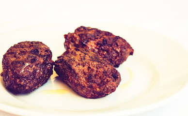 homemade fried minced meat balls horsemeat on white plate, traditional Sicilian dish.