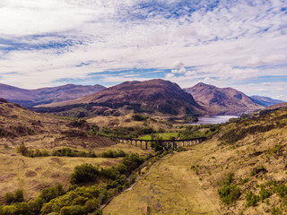 Glenfinnan viaduct and historical train in Scotland