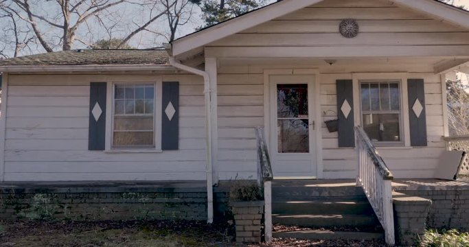 Front Entrance Of A One Story Rundown Empty Single Family Home