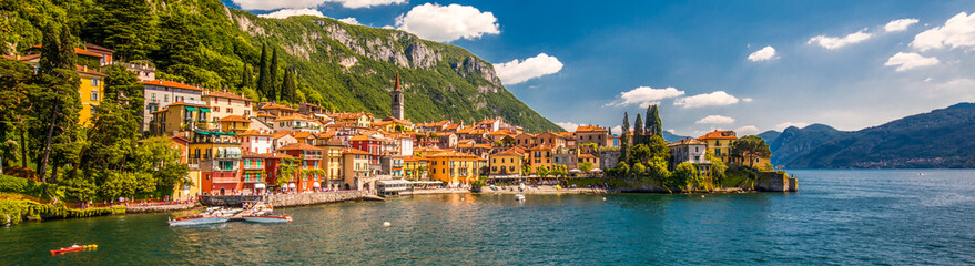 VARENNA, ITALY - June 1, 2019 - Varenna old town with the mountains in the background, Italy, Europe - obrazy, fototapety, plakaty