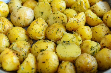 Roasted young potatoes with herbs close-up