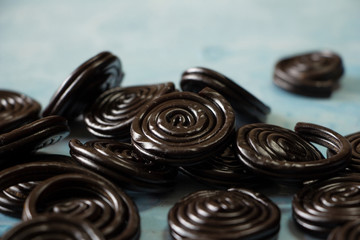 Detail of licorice candy spirals on blue background