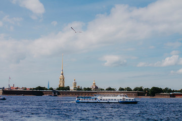 Fototapeta premium St. Petersburg, Russia - May 27, 2019. Tourist ships ride along the rivers and canals of tourists around St. Petersburg.