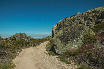 Trail passing through rocky terrain on highlands