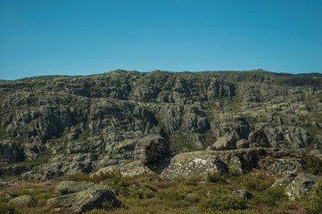 Fototapeta na wymiar Rock formations covered by moss and lichen on highlands
