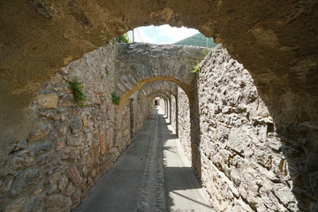 Passage under stone arches inside the fortified village of Villefranche de Conflent, Pyrenees Orientales, Occitanie, France