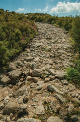 Trail passing through rocky terrain on highlands