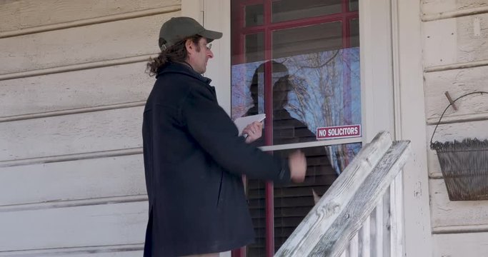 Persistent, determined, man keeps knocking on the front door of a house